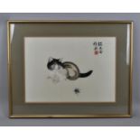 A 20th century Chinese silk embroidery of a kitten, signed with red embroidered seal, within a