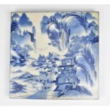 A large Chinese Qing dynasty blue and white porcelain tile, 19th century, depicting mountains,