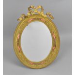 A French Belle Epoque ormolu mounted table mirror, the glass framed with ribbon surmount and