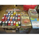 A collection of diecast model Mini cars, along with two car owners' manuals, various car magazines