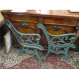 A pair of green painted cast iron garden bench ends Location: G