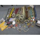 Costume jewellery to include necklaces, bangles, an African rosary pea necklace and a set of three