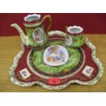 A Continental porcelain tray and matching teapot and a sugar bowl having a central motif of a