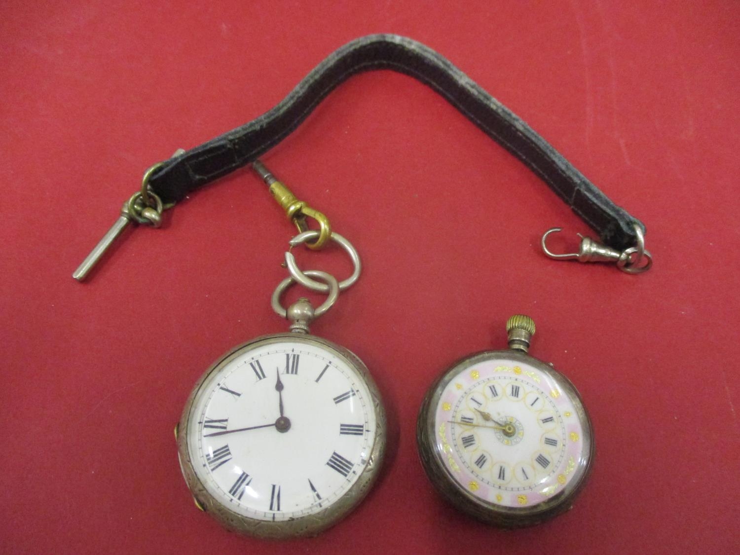 Two Continental silver pocket watches and one leather pocket watch strap Location: Cab