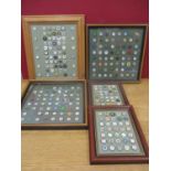 Five framed and mounted collections of golf ball markers to include enamelled and foreign examples