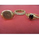 A 9ct gold signet ring A/F, 3g together with a 9ct gold ring with central garnet, total weight 1.65g