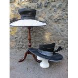 A Peter Bettley navy and cream straw formal hat with navy silk band and large navy feather