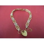 A 9ct gold gatelink bracelet with locket and safety chain, 7.1g