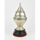 A Portuguese silver lidded urn, with faceted body and conical lid with urn finial, on a circular