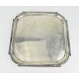 An early 20th century English silver waiter by Cohen & Charles, London 1913, of plain square form