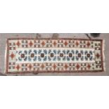 A Turkish tribal hand woven wool runner, with repetitive motif along the centre and geometrical