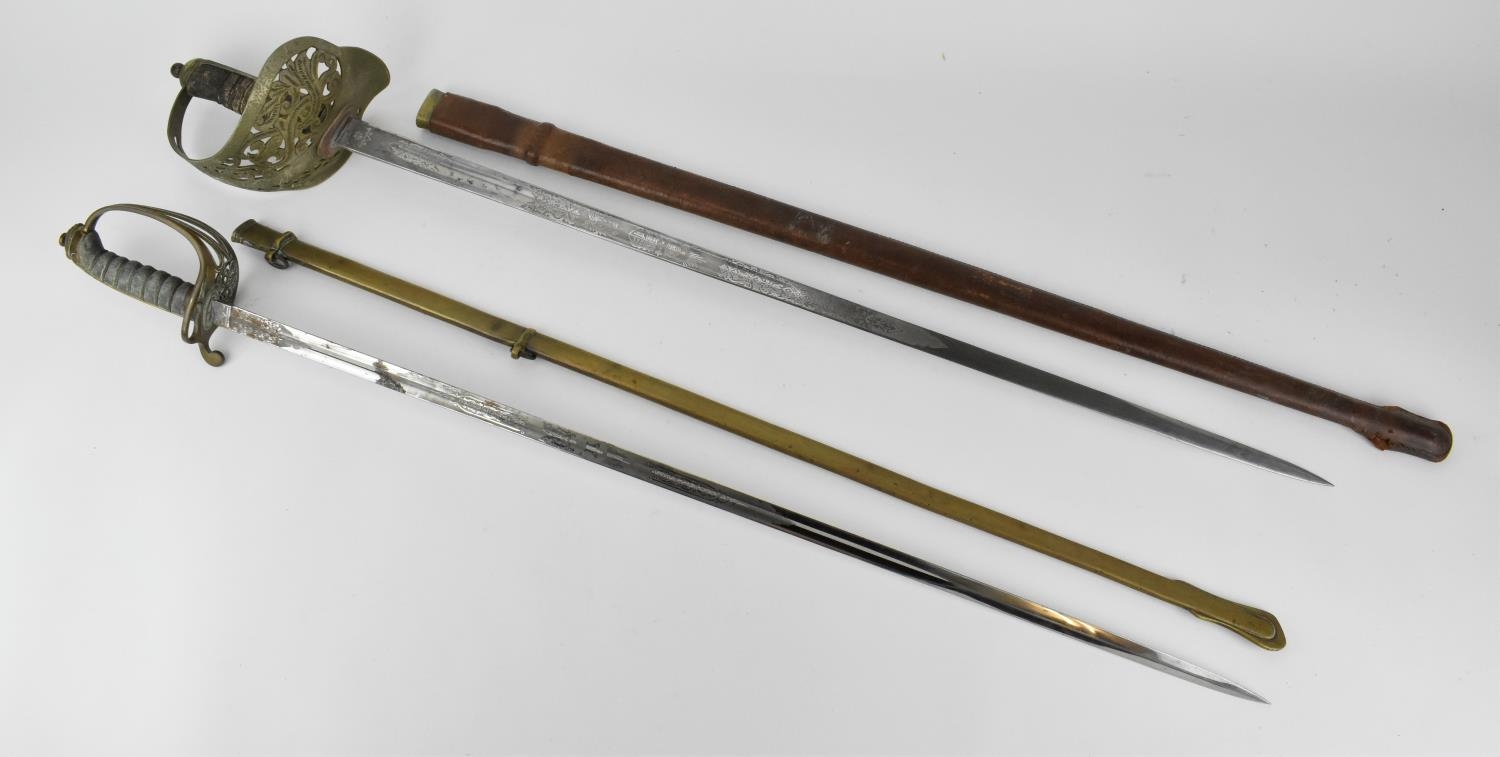 Two British army dress swords, one with leather scabbard, the grip with shagreen and large hoop