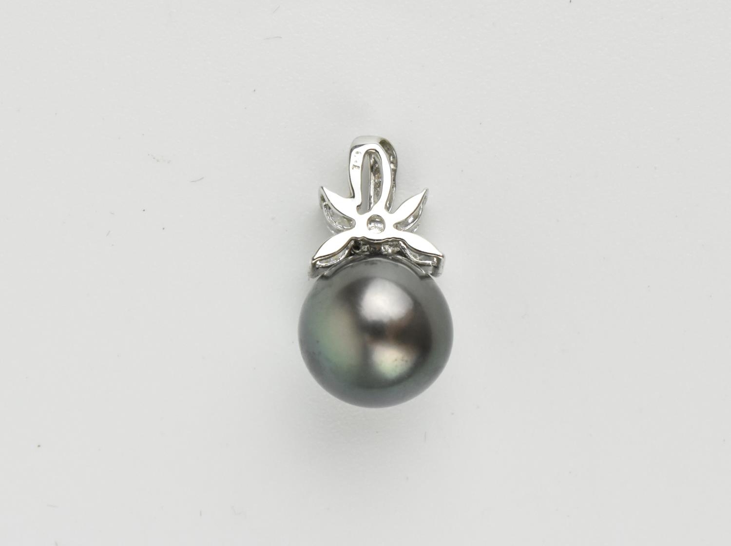 An 18ct white gold, diamond and Tahitian pearl pendant, the pearl surmounted with a diamond floral - Image 2 of 2