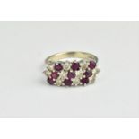 An 18ct white gold, ruby and diamond set dress ring, designed with three rows of alternating