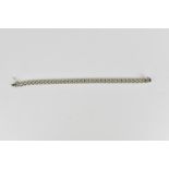 An 18ct white gold bracelet, with jubilee style link and figure eight safety clasp, 20 cm long, 21