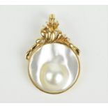 A 14 ct yellow gold, diamond and mabe pearl pendant, of circular form with surmount of foliate