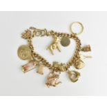 A 9ct yellow gold curb link charm bracelet, with multiple charms such as animals, thimble, cradle,