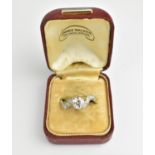 An 18ct gold, platinum and diamond ring, with central brilliant cut diamond, flanked with rows of