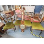 A Set of four aesthetic, inlaid, ebonized dining chairs with upholstered seats and a 19th century