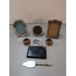 Three silver photograph frames together with a pair of silver mounted Doulton Lambeth salts, a