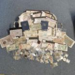 A mixed lot of coins and banknotes from around the world to include mid to late 20th century British