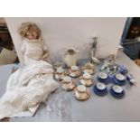 A 20th century German doll with bisque porcelain head and leather arms and legs together with