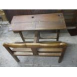 A French oak double school desk with hinged top and space for two ink wells, the plank constructed