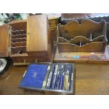 An early 20th century stained pine desk tidy, a stationary box and a cased Archbutt geometry set.