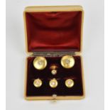 A cased set of yellow metal and diamond dress and collar studs, each piece with central star mounted
