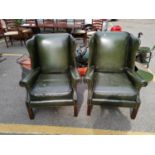 A pair of green leather wing back armchairs by Pegasus Location: C