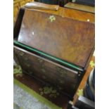 An early 18th Century walnut veneered bureau with feathered edge banding, fall flap with brass