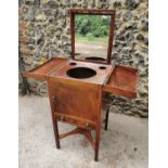 A late Georgian mahogany gentleman's wash stand, the opening top with pull out mirror and