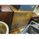 An oak chest of two short and three long drawers with lacquered and patinated brass Arts & Crafts