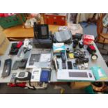 A mixed lot of electronics and cameras to include an I-Phone 6, Dell laptop battery, Nikkormat