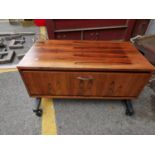 A Rosewood veneer TV stand with drawer, raised on metal stand and castors, 44 h x 92 w x 57cm d