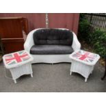 A Lloyd loom style white painted two seater sofa with loose black fabric cushions, with a pair of