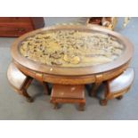 A mid 20th century Chinese hardwood carved oval coffee table with six nesting tables A/F, on