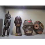 Equatorial Guinea African wood and leather clad fetish and one carved wooden figure and two masks