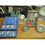 A group of silver items to include three early 20th century photograph frames, a cut glass and