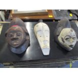 Three carved African wooden masks, Gabon, Fang peoples, two with lime painted decoration