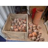 A large selection of vintage terracotta plant pots, various sizes, and a chimney pot, along with a