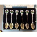 A set of six early 20th century silver spoons, the finials with enamelled golf scenes, 120g