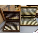 A set of silver plated dessert knives and forks and a set of silver plated fish knives and forks,