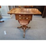 An early 19th century rosewood cross banded mahogany drop leaf work/sewing table, the two drawers