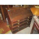 A Georgian mahogany bureau, the flame mahogany fall flap with gadroon edge revealing a pigeon hole