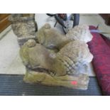 A pair of Victorian concrete stone garden ornaments in the form of crouching lions on rectangular