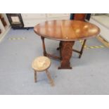 An arts and crafts stool, the seat carved with a man in a bath together with an early 20th century