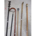 Mixed walking sticks to include an early 20th century silver topped stick together with an African
