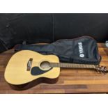 A Yamaha F310 acoustic guitar and carrying case Location: G