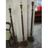 A group of three Indian carved wooden standard lamps Location: G